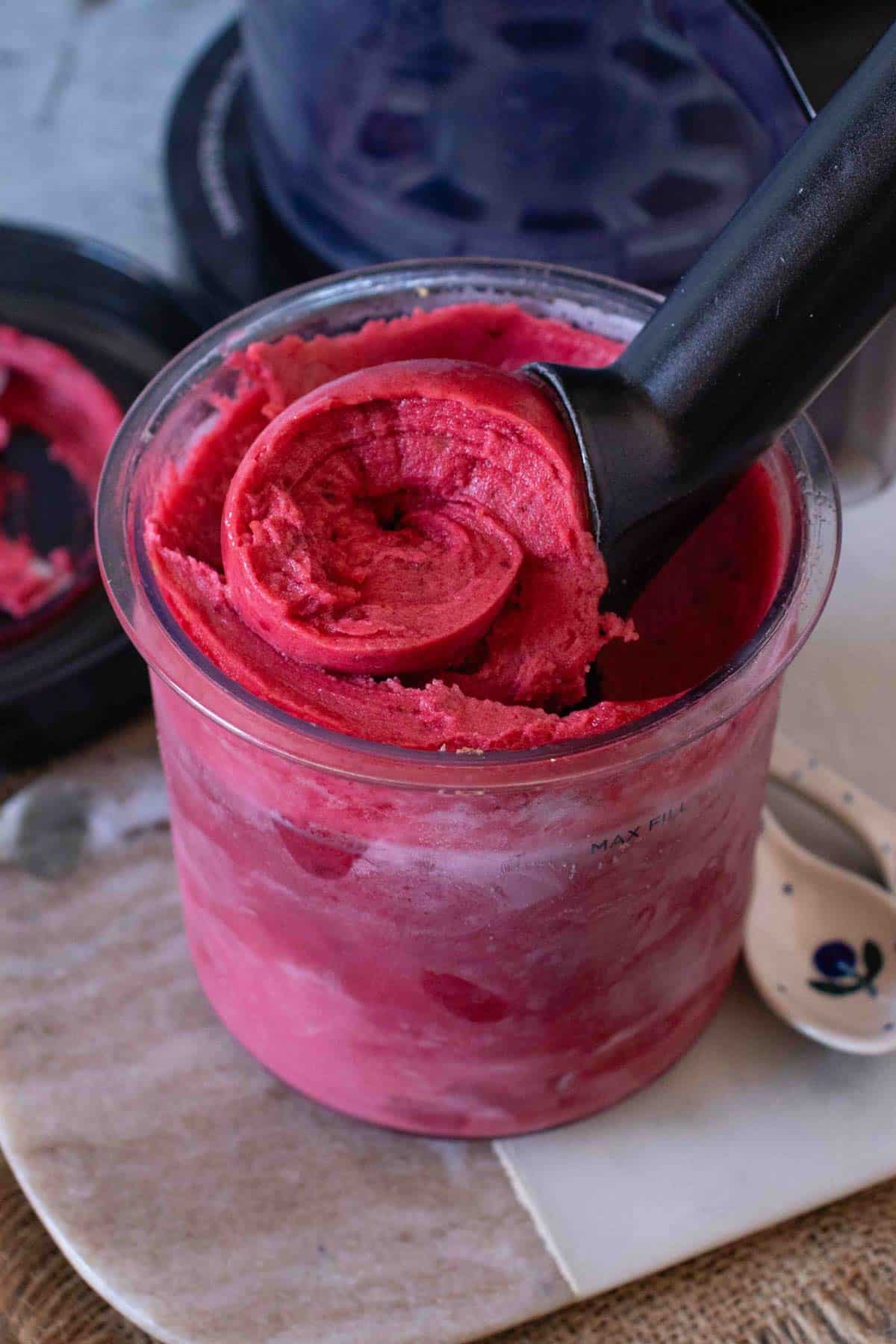 Delicious dark pink blackberry & apple sorbet being scooped out of a Ninja Creami pot