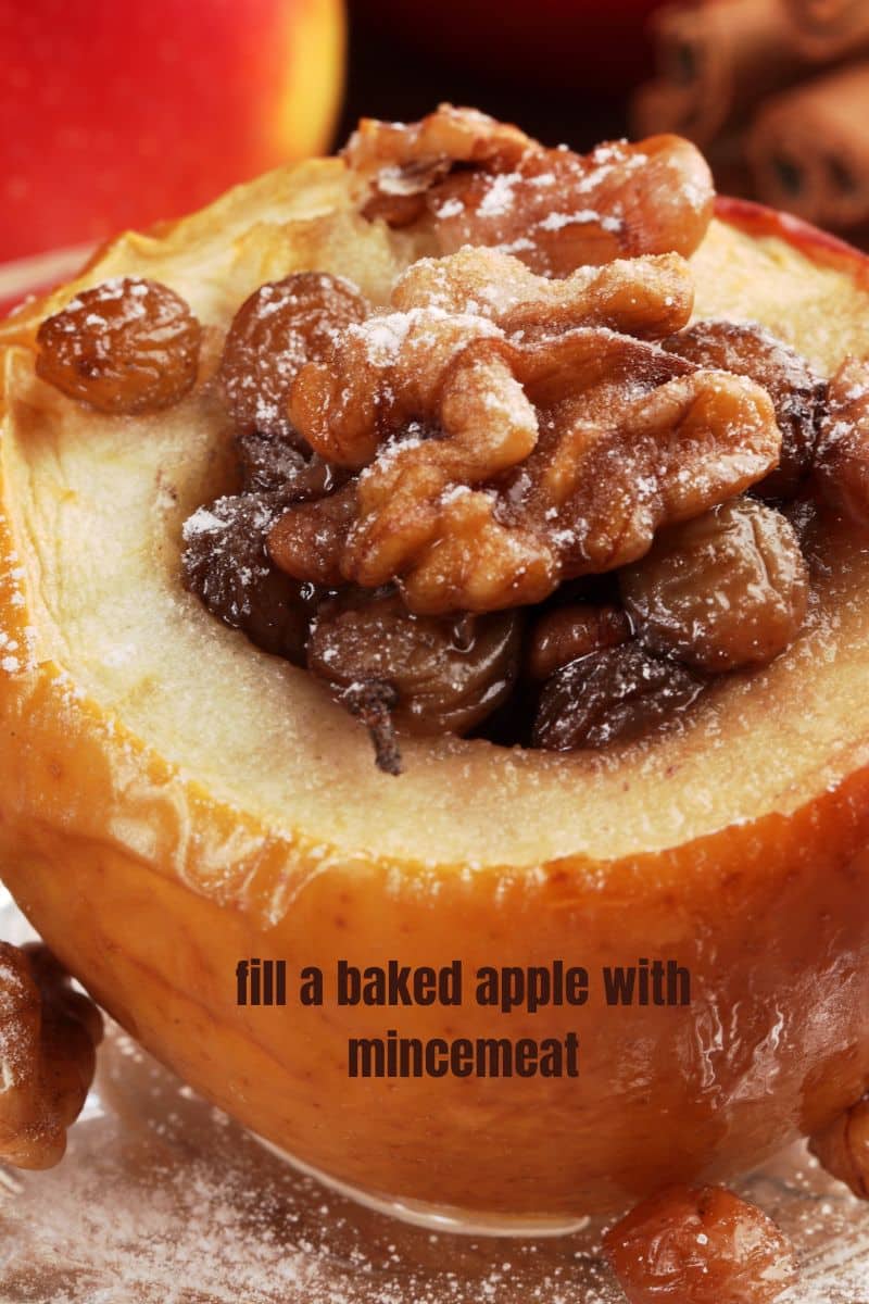 a baked apple topped with mincemeat and topped with nuts