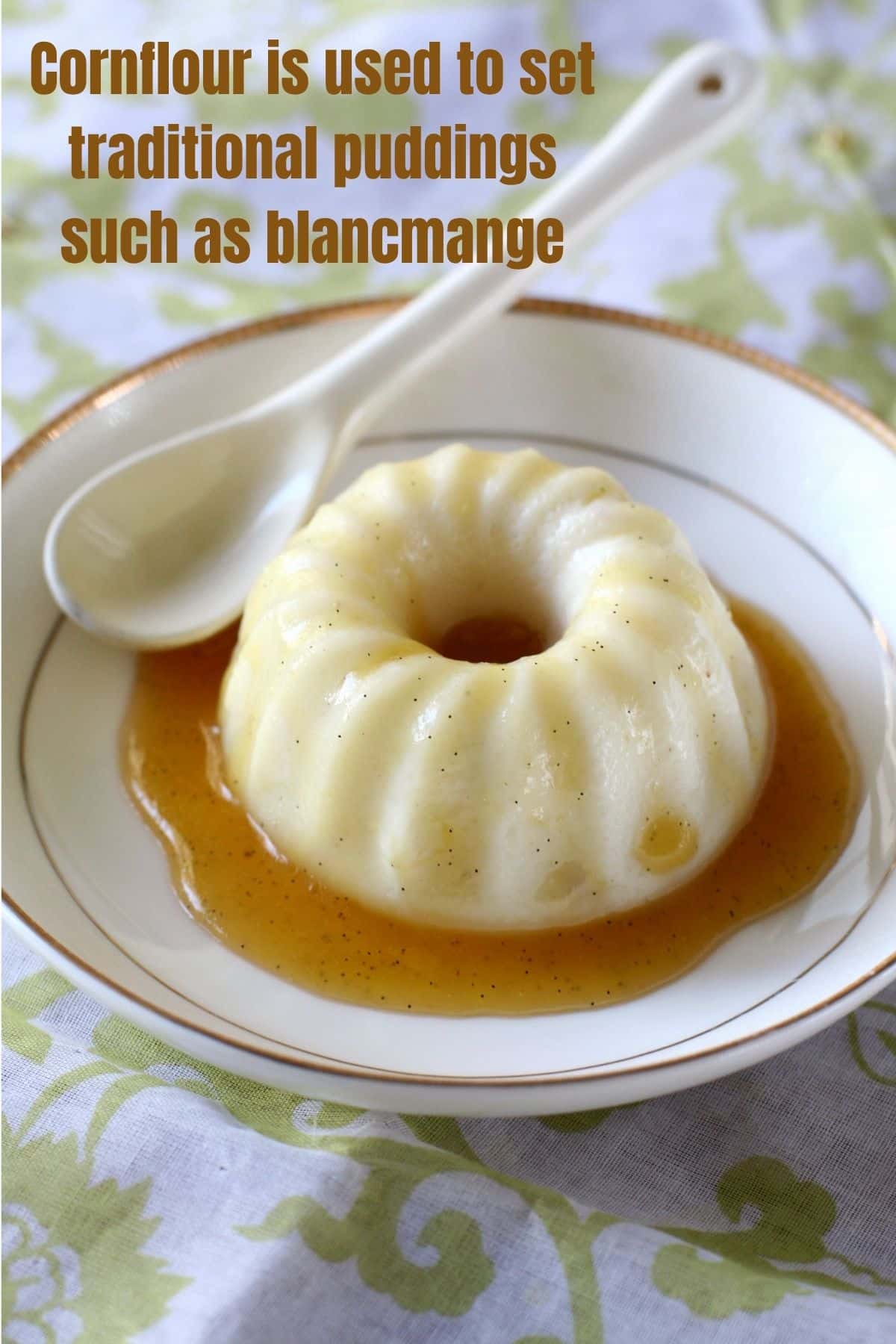 a white blancmange on a white and gold plate