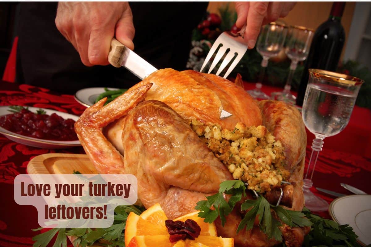 a roasted turkey is being carved on a table set for Christmas dinner