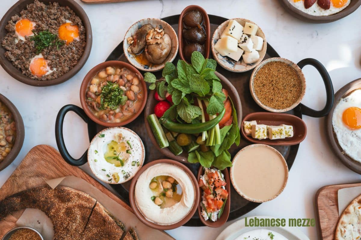 a top down view of a table set with colourful bowls of lebanese mezze