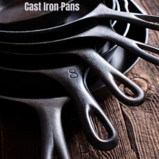 a stack of 6 cast iron skillets