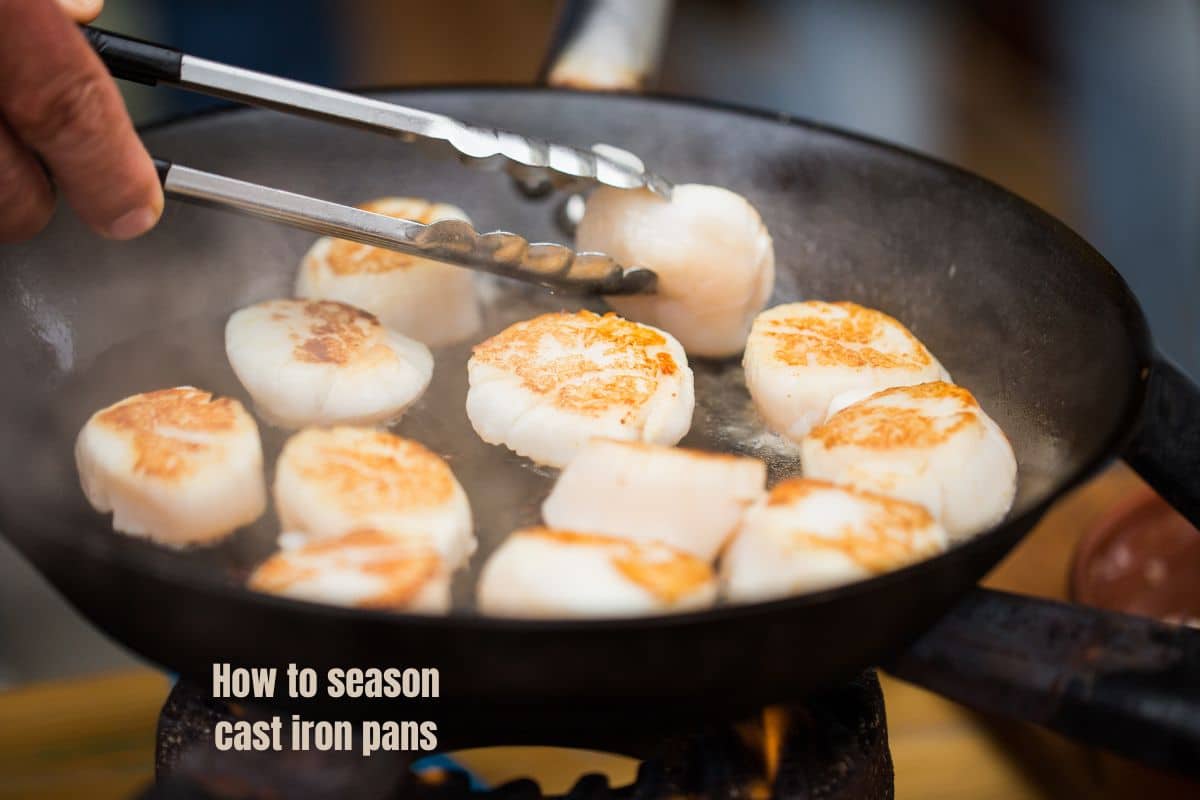 a cast iron frying pan of sizzling steaming scallops